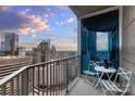 Balcony with city views and small table and chairs at 210 Church St # 3207, Charlotte, NC 28202