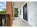 Front porch with modern black door and wood columns at 113 Oakwood Dr, Kings Mountain, NC 28086