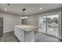 Kitchen island with granite countertops and access to deck at 314 S Government St, Lincolnton, NC 28092