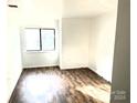 Living room with vinyl plank flooring and large window at 4821 Spring Lake Dr # C, Charlotte, NC 28212