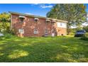 Rear view of a brick home with a large grassy yard at 140 Steep Ln, Statesville, NC 28625