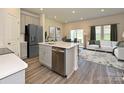 Open concept kitchen with island and stainless steel appliances at 1253 Falling Acorn Ln, Concord, NC 28027