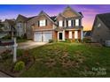 Two-story house with stone and shingle exterior, two-car garage at 3392 Brackhill St, Davidson, NC 28036