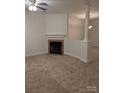 Living room with fireplace and neutral carpeting at 6442 Terrace View Ct, Charlotte, NC 28269