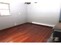 Simple bedroom with hardwood floors and neutral walls at 1131 Meandering Ln, Lincolnton, NC 28092