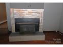 Stone fireplace with a wood-burning stove at 1131 Meandering Ln, Lincolnton, NC 28092