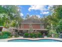Brick house with a large, kidney-shaped pool and fountain at 14001 Cabarrus Station Rd, Midland, NC 28107