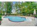 Inviting kidney-shaped pool with a view and water features at 14001 Cabarrus Station Rd, Midland, NC 28107