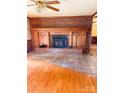 Brick fireplace with wood mantel and hearth in a living room at 1610 Sierra Rd, York, SC 29745