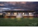 Ranch home with front porch and landscape lighting at 16356 Little Creek Rd, Albemarle, NC 28001