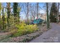 Teal ranch home with a long driveway and wooded lot at 702 Forest Hill Dr, Shelby, NC 28150