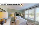 Bright and airy bedroom with large windows and neutral decor at 125 Sari St, Troutman, NC 28166