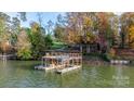 An elevated boat dock with a hot tub, swim ladder, and kayak storage at 3453 6Th Street Nw Dr, Hickory, NC 28601