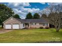 Brick ranch house with a three-car garage and a well-maintained lawn at 2707 24Th Street Ne Ct, Hickory, NC 28601