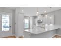 Bright kitchen entry with white cabinets and wood floors at 1031 Seven Sisters Ave, Monroe, NC 28110