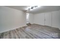 Spacious basement with gray vinyl flooring and an exterior door at 268 Simrill St, Rock Hill, SC 29730