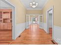 Hardwood floors and neutral wall tones in a long hallway at 405 7Th St, Spencer, NC 28159