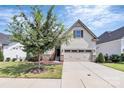 Attractive Craftsman style home with a two-car garage and landscaped front yard at 14008 Little Spring Ct # 391, Charlotte, NC 28278