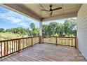 Wooden deck with railing and treetop views at 14008 Little Spring Ct # 391, Charlotte, NC 28278