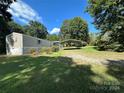 Tan mobile home with carport, covered porch, and spacious yard at 2547 Evening Dr, Claremont, NC 28610