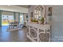 Bright entryway with decorative console table and mirror, leading to dining area and backyard view at 311 Coronado Ave # 62, Matthews, NC 28104