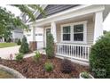Front porch with white railing and stone accents at 14217 Ridgewater Way, Charlotte, NC 28278
