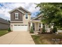 Two-story home with a front porch at 14217 Ridgewater Way, Charlotte, NC 28278