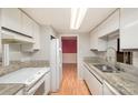 Kitchen with granite countertops, stainless steel sink, and white cabinets at 8017 Regent Park Ln, Charlotte, NC 28210