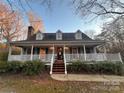 Charming house with wrap-around porch and landscaping at 1409 Trinity Church Rd, Monroe, NC 28112