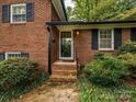 Front entrance with brick steps and black shutters at 325 Rosemary Ln, Gastonia, NC 28054