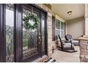 Elegant front door with a wreath, leading to a porch with rocking chairs at 5079 Barcroft Dr, Indian Land, SC 29707