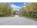 House with driveway and landscaping, nestled in a wooded setting at 3171 Stonemill Path, Sherrills Ford, NC 28673