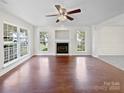 Spacious living room with hardwood floors, fireplace, and large windows at 325 Pelling Dr, York, SC 29745