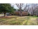 Brick ranch house nestled on a lot with mature trees at 2808 Findley Rd, Statesville, NC 28625