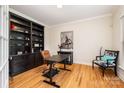 Home office features built-in shelving and hardwood floors at 8127 Caliterra Dr, Charlotte, NC 28227