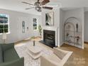 Virtually staged living room with fireplace and shelving at 1075 Stirrup Nw Pl, Concord, NC 28027