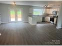 Modern kitchen with stainless steel appliances and access to backyard at 201 Rocky River Rd, Oakboro, NC 28129