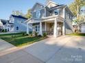 Two-story gray house with a stone facade and covered porch at 558 Geneva Cir, Gastonia, NC 28056