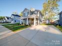 Two-story gray house with a stone facade and covered porch at 558 Geneva Cir, Gastonia, NC 28056