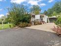 Mobile home with a carport and a well-maintained yard at 7676 Shoupes Grove Church Rd, Hickory, NC 28612