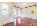 Bright entryway with hardwood floors, stained-glass window, and wainscoting at 878 Treasure Ct, Fort Mill, SC 29708