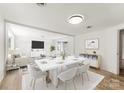 Open concept dining room with hardwood floors and white table at 217 Burrage Ne Rd, Concord, NC 28025