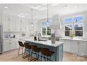 Modern kitchen with white cabinets and a blue island at 3109 Colyer Pl, Charlotte, NC 28205