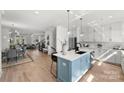 Open concept kitchen with a blue island and dining area at 3109 Colyer Pl, Charlotte, NC 28205