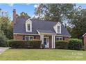 Brick ranch home with a covered entryway and well-manicured lawn at 5938 Scots Bluff Dr, Charlotte, NC 28227