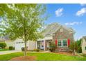 Tan house with white garage doors and red shutters at 8928 Carneros Creek Rd, Charlotte, NC 28214