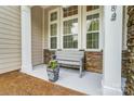 Front porch with stone accents and a gray bench at 8928 Carneros Creek Rd, Charlotte, NC 28214