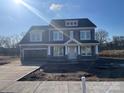 Two-story home with gray siding, stone accents, and a two-car garage at 5735 Allburn Pkwy, Concord, NC 28027