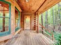 Wooden porch with a view of the surrounding woods at 5082 Mount Carmel Rd, Heath Springs, SC 29058