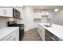 Modern kitchen with white cabinets and stainless steel appliances at 2020 Skyhawk Dr, York, SC 29745